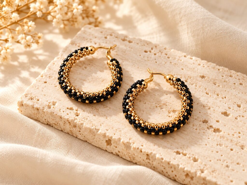 Marra earrings jewelry styled on ivory linen and warm stone